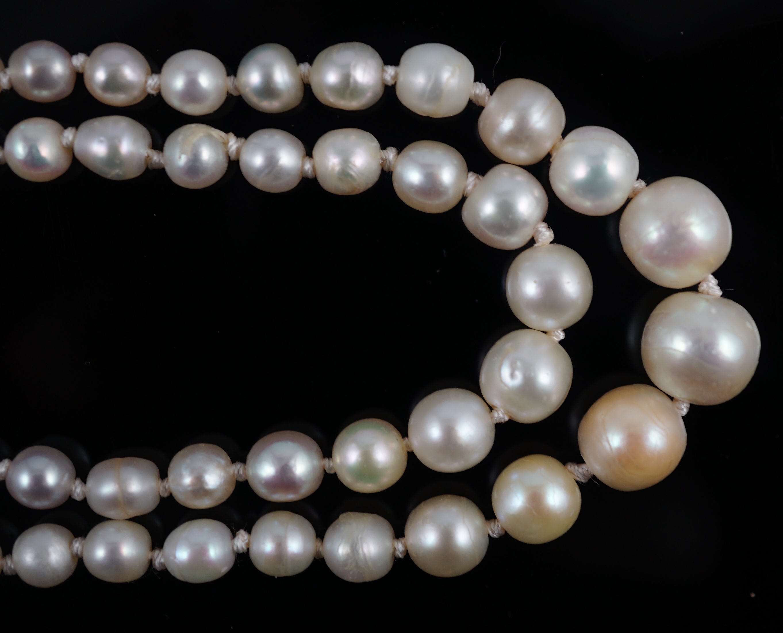 A twin strand graduated cultured pearl necklace, with gold and six stone diamond set rectangular clasp